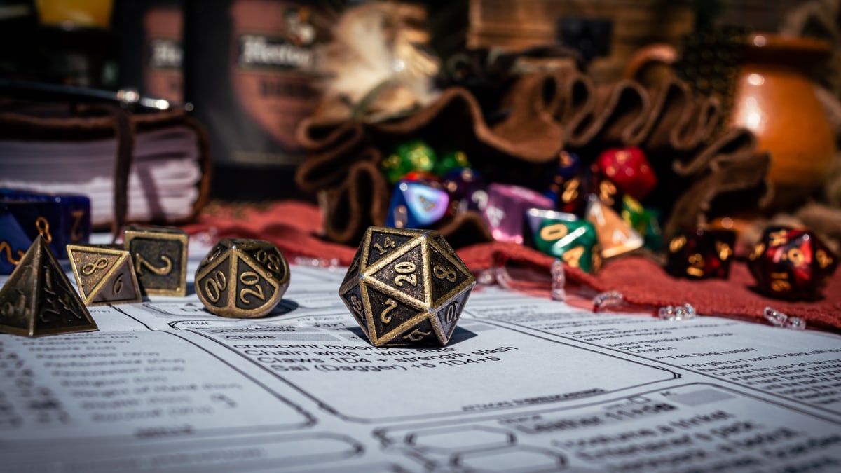 Polyhedral dice resting on a character sheet and campaign notes