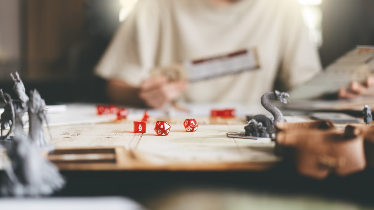 A player fully involved in a tabletop role-playing game while her notebook stays closed